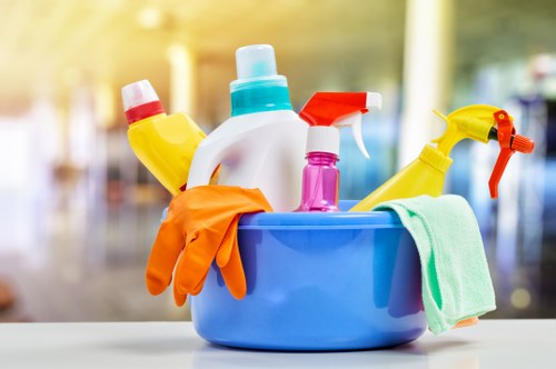 Cleaner using protective gloves and mask during carpet cleaning
