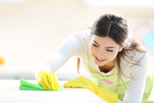 A technician performing professional rug cleaning in Kilburn